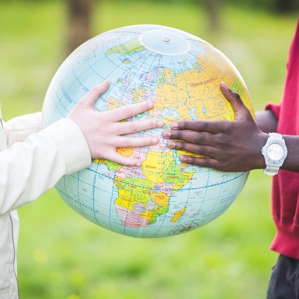 Two people holding a globe